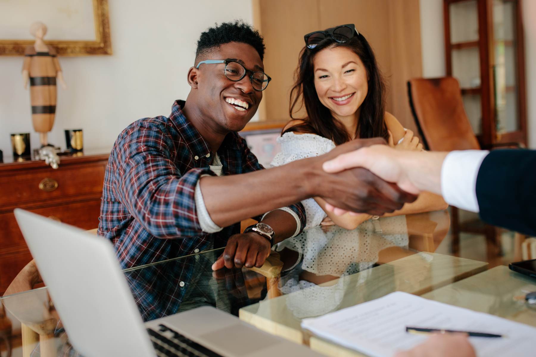 Real estate agent shaking hands with his client