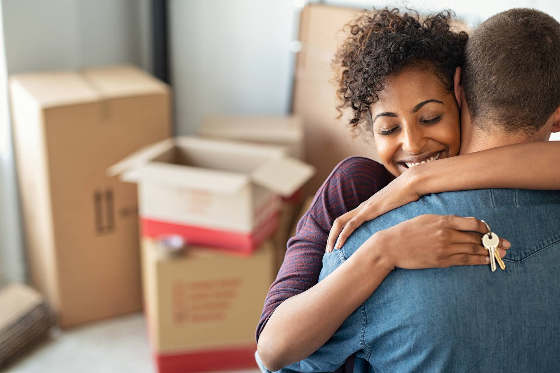 Happy couple hugging on moving day